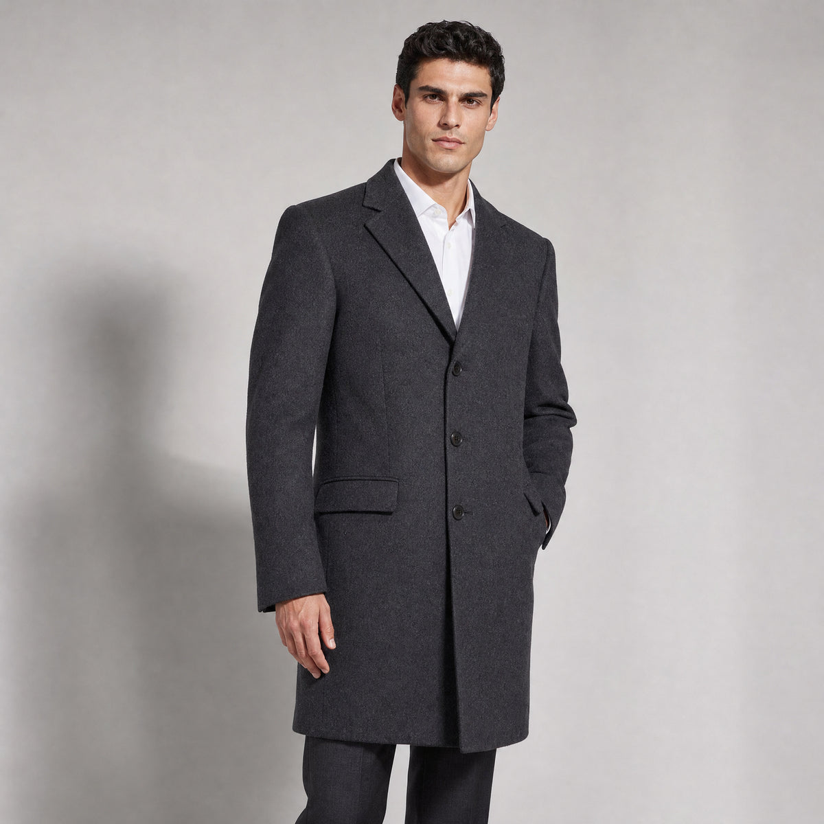 The Broker Men's Tailored Overcoat in Dark Charcoal, worn by model
