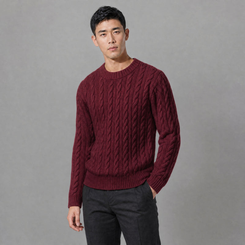 The Cartographer Men's Cable-Knit Crewneck Sweater in Burgundy, worn by model