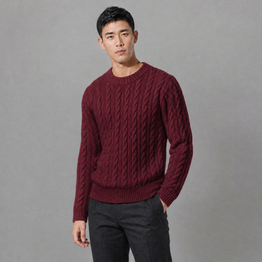 The Cartographer Men's Cable-Knit Crewneck Sweater in Burgundy, worn by model