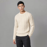 The Cartographer Men's Cable-Knit Crewneck Sweater in Cream, worn by model