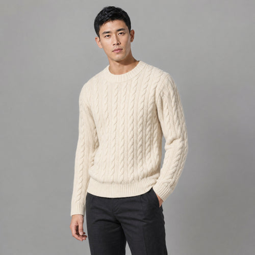 The Cartographer Men's Cable-Knit Crewneck Sweater in Cream, worn by model