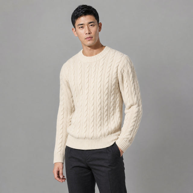 The Cartographer Men's Cable-Knit Crewneck Sweater in Cream, worn by model