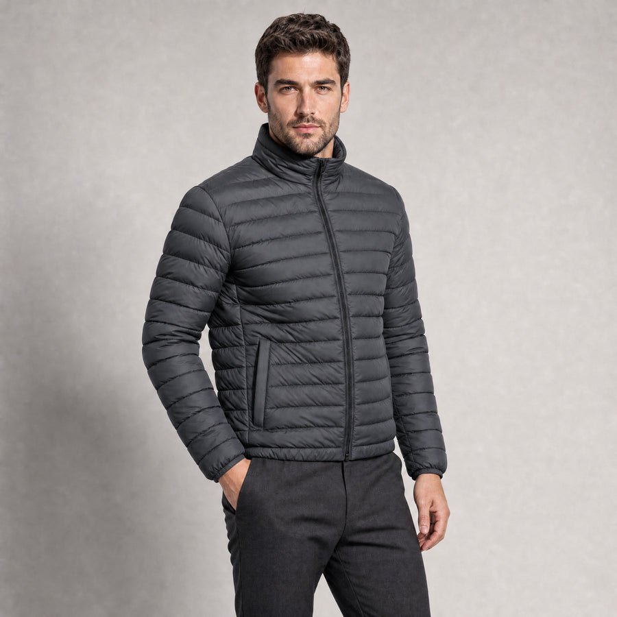The Draftsman Men's Quilted Puffer Jacket in Graphite, worn by model