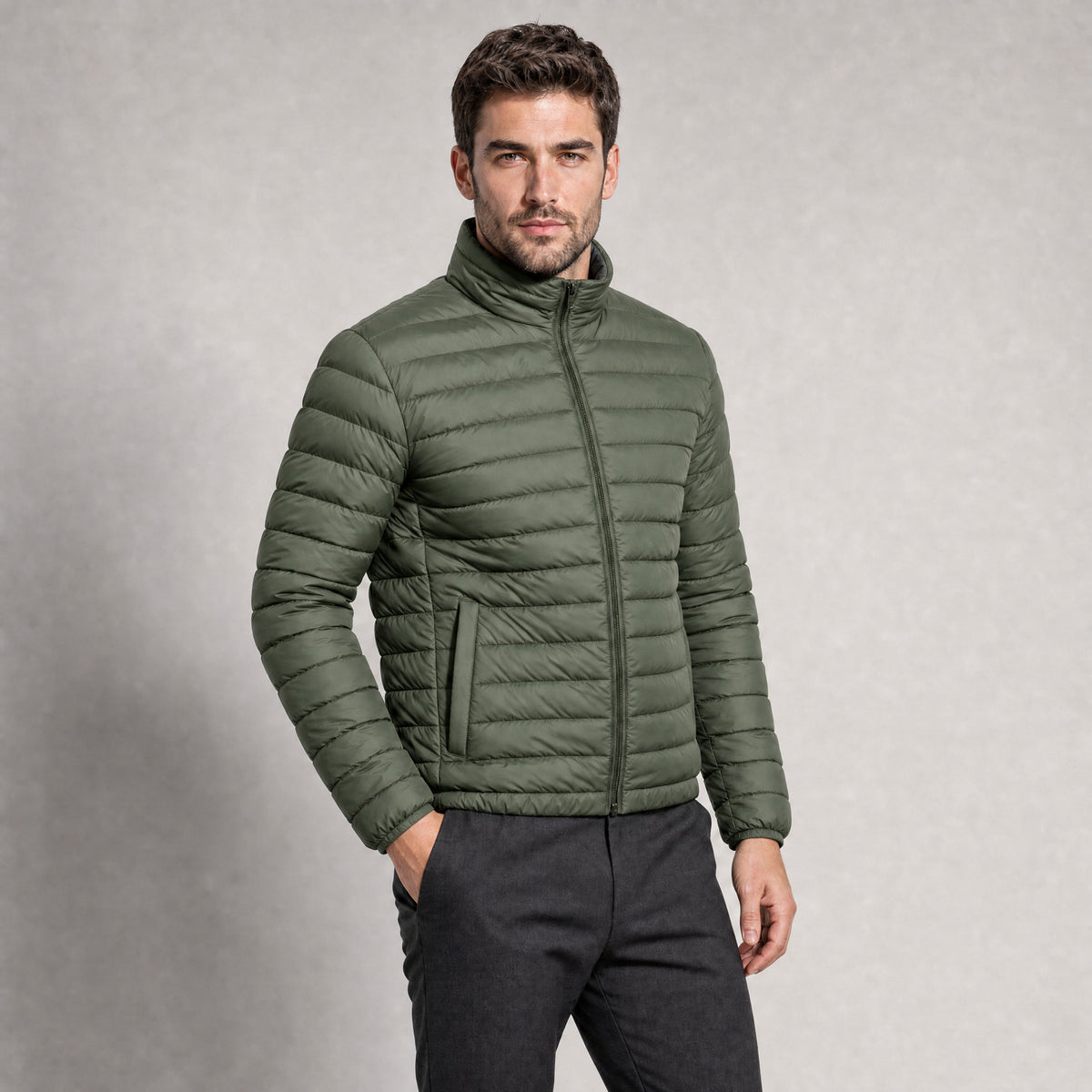 The Draftsman Men's Quilted Puffer Jacket in Moss Green, worn by model