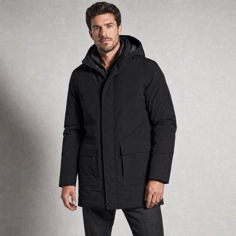 The Editor Men's Hooded Winter Parka in Jet Black, worn by model