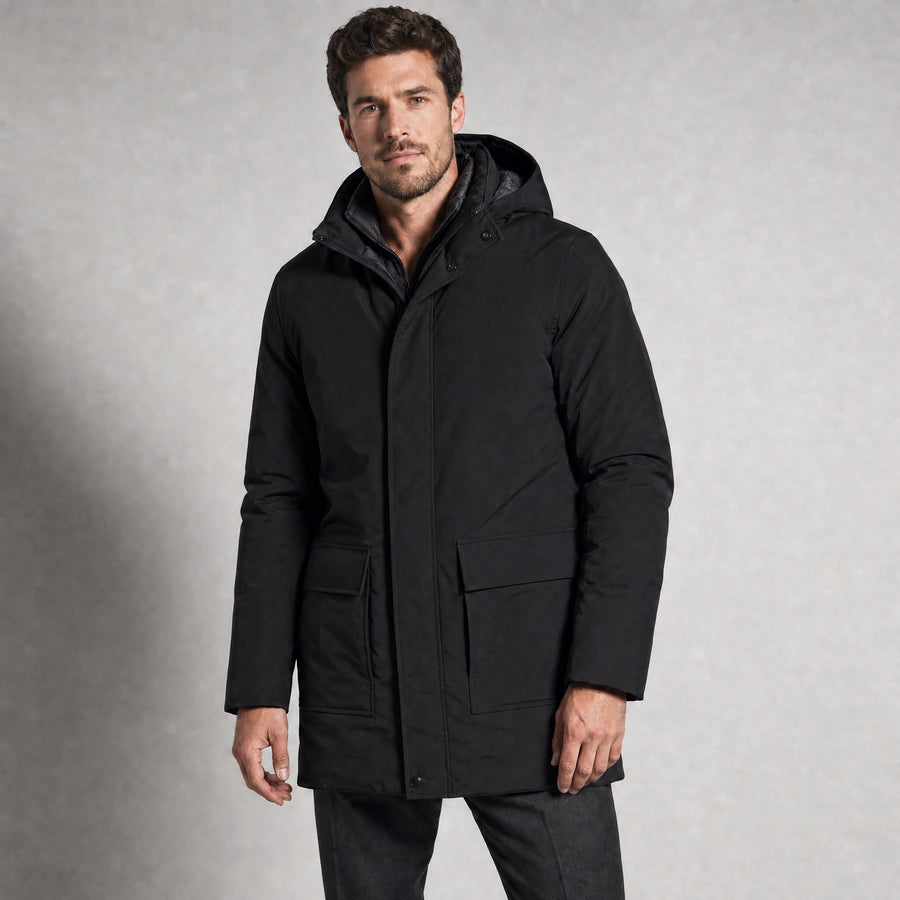 The Editor Men's Hooded Winter Parka in Jet Black, worn by model