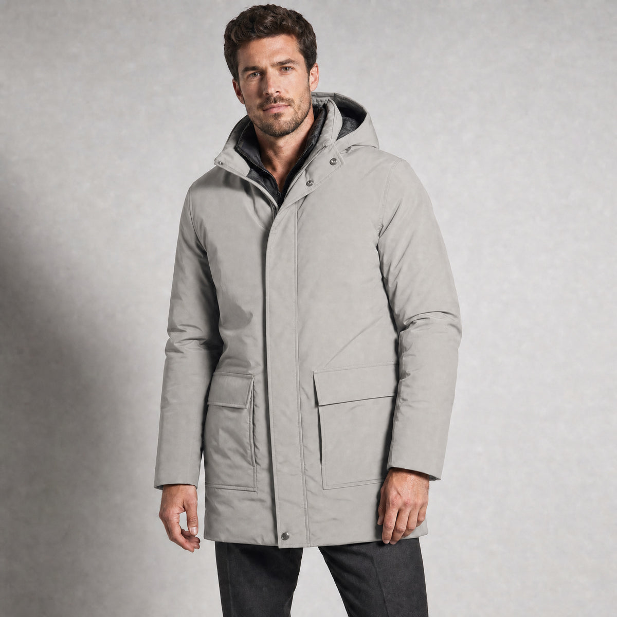 The Editor Men's Hooded Winter Parka in Stone Grey, worn by model