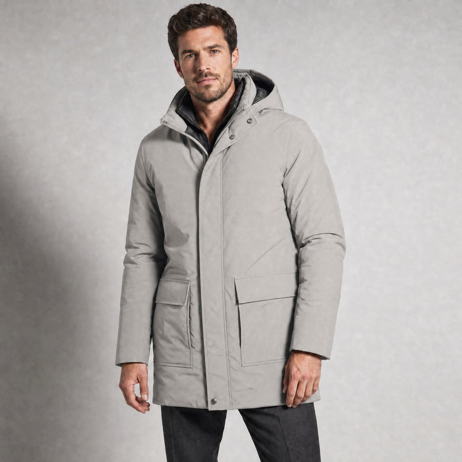 The Editor Men's Hooded Winter Parka in Stone Grey, worn by model