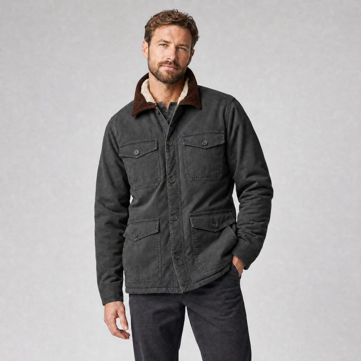 The Foreman Men's Fleece-Lined Canvas Field Jacket in Coal, worn by model