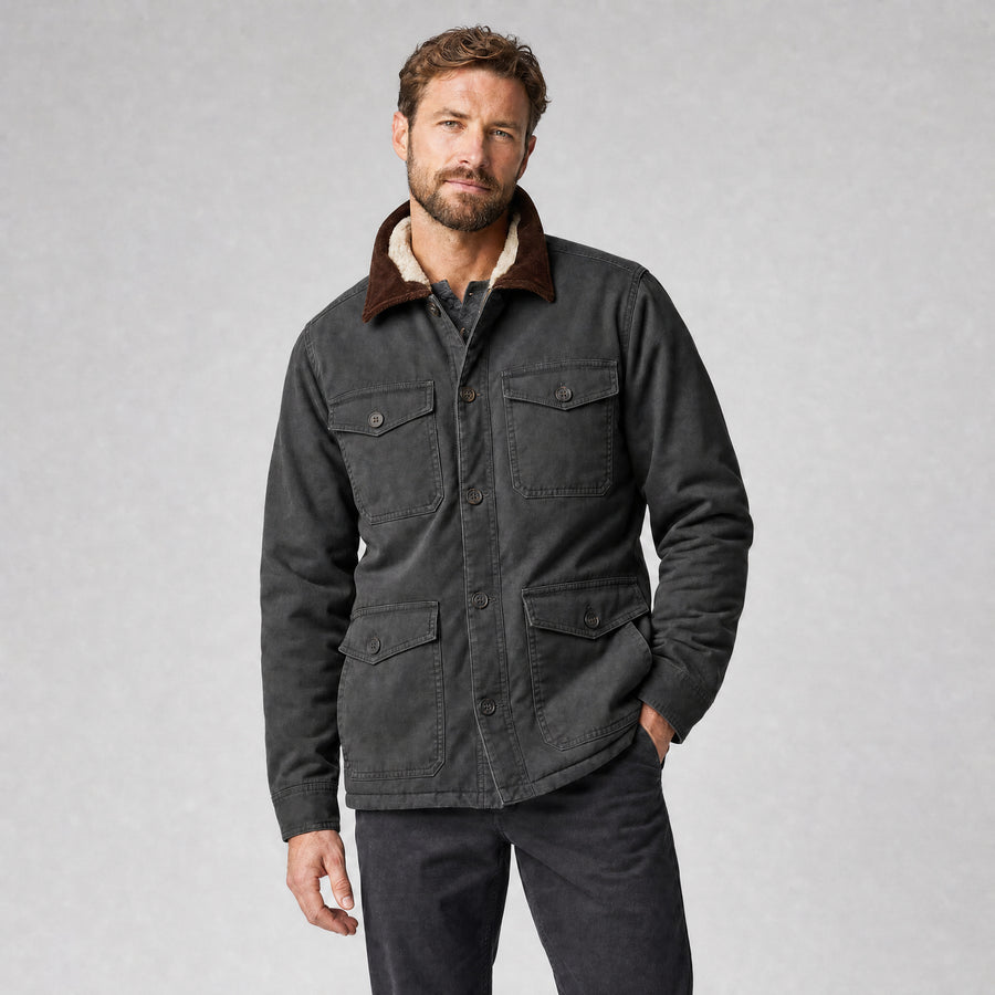 The Foreman Men's Fleece-Lined Canvas Field Jacket in Coal, worn by model