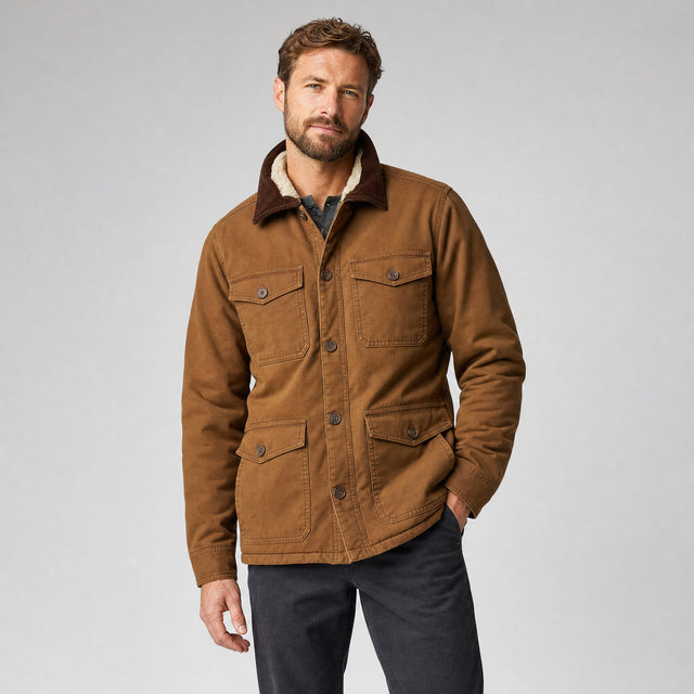 The Foreman Men's Fleece-Lined Canvas Field Jacket in Saddle Brown, worn by model